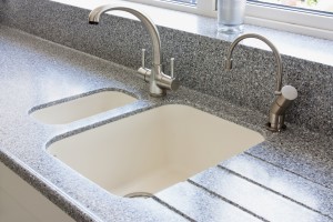 granite kitchen worktop and ceramic sunken sink with hot water tap and normal modern tap